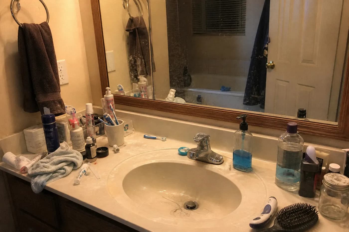 Messy bathroom vanity before house cleaning