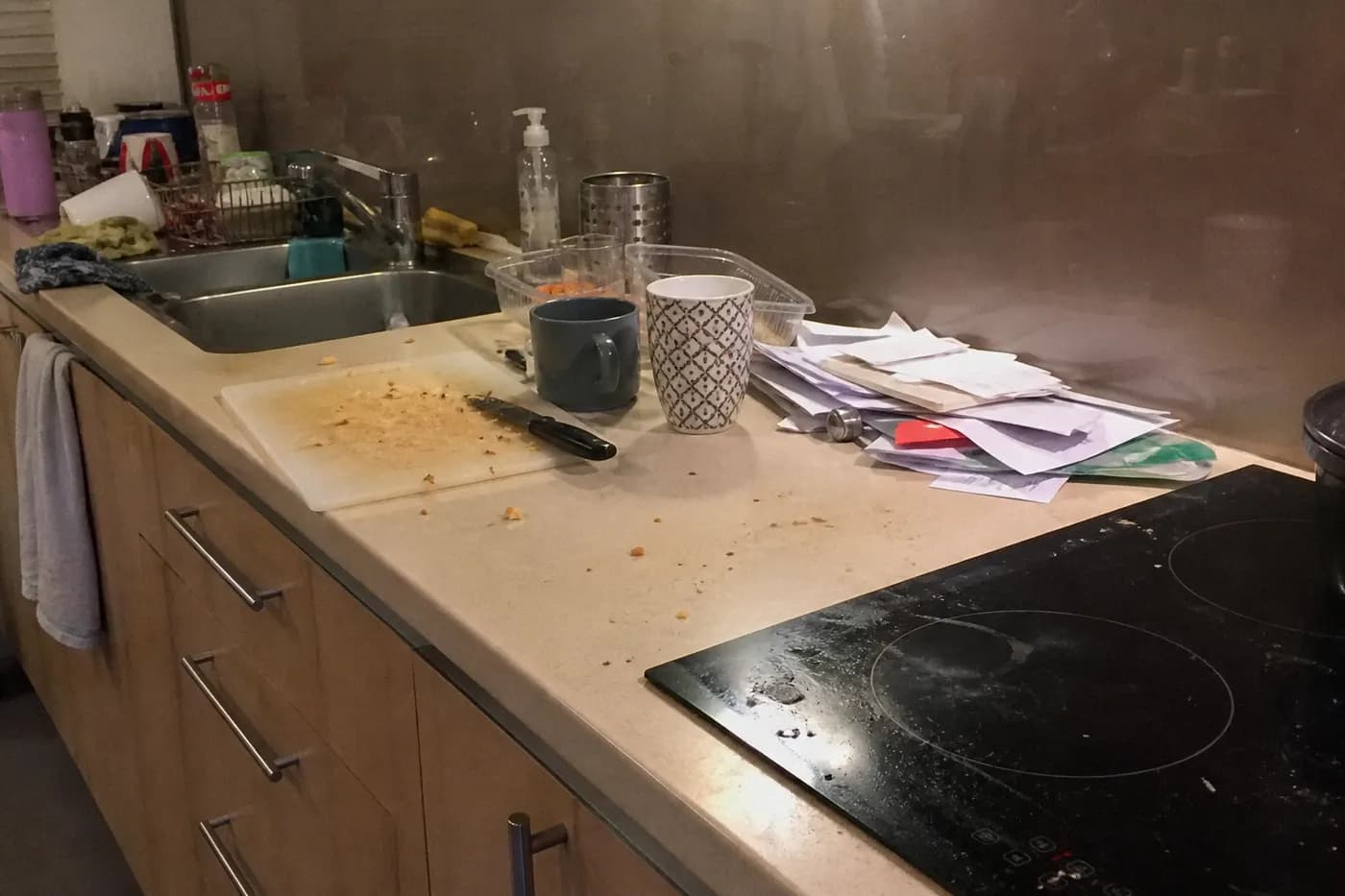 Messy kitchen benchtop before house cleaning