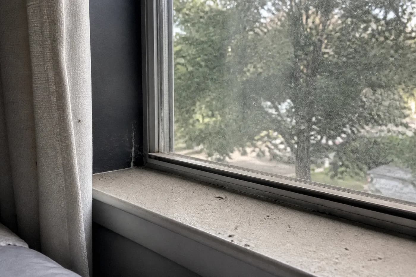 Dusty windowsill and glass before house cleaning