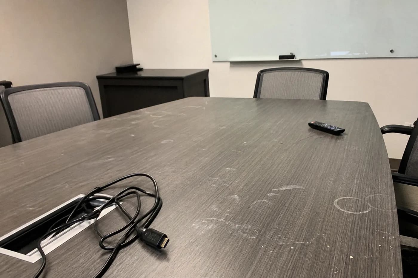 Dusty meeting room table before cleaning